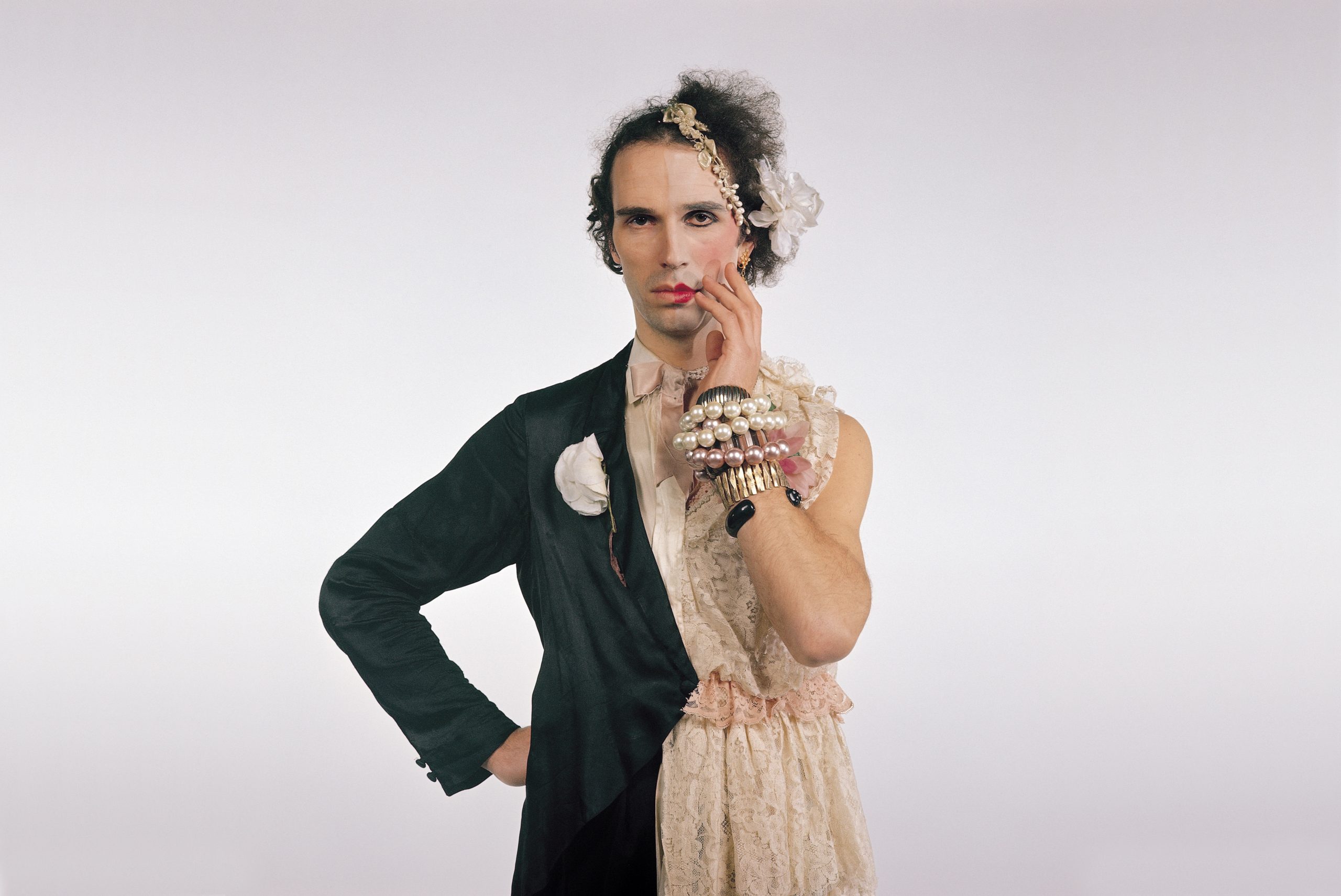 Andrew Logan dressed in half a tuxedo and half a dress.