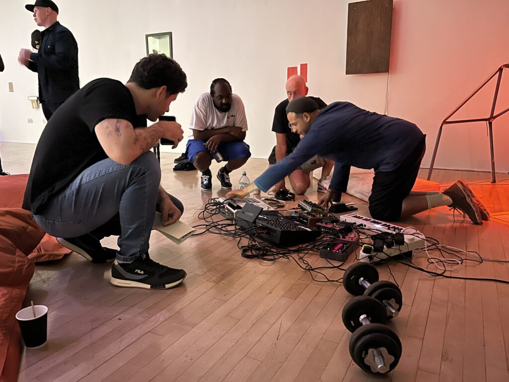 Tom Harris giving a demonstration of his equipment to 3-4 people