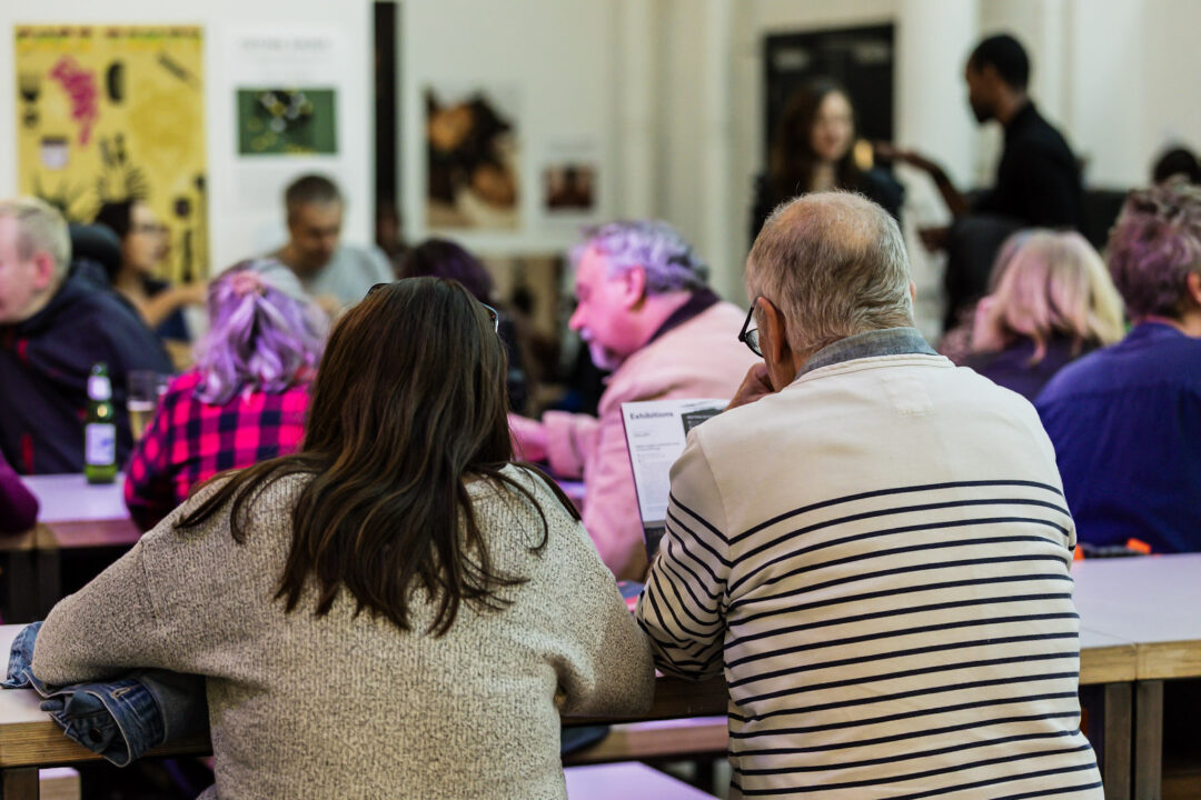 A photograph of people attending an exhibition launch