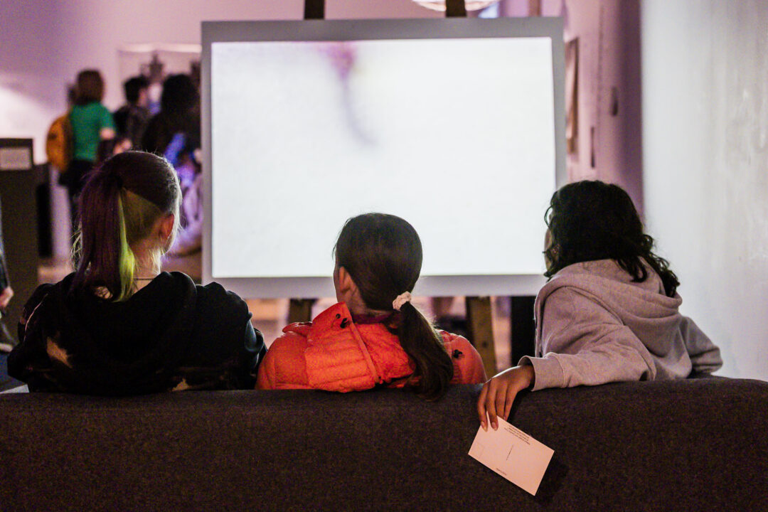 A photograph of people attending an exhibition launch