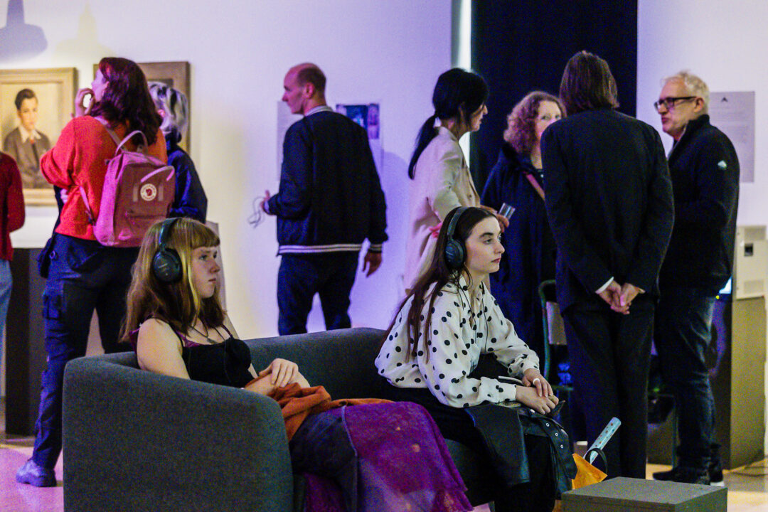 A photograph of people attending an exhibition launch