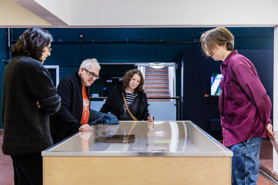 A photograph of people attending an exhibition launch