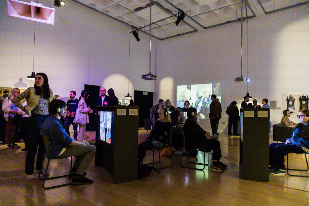 A photograph of people attending an exhibition launch