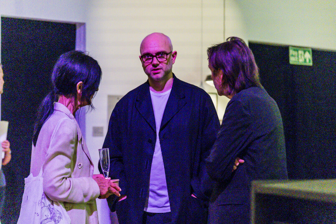 A photograph of people attending an exhibition launch
