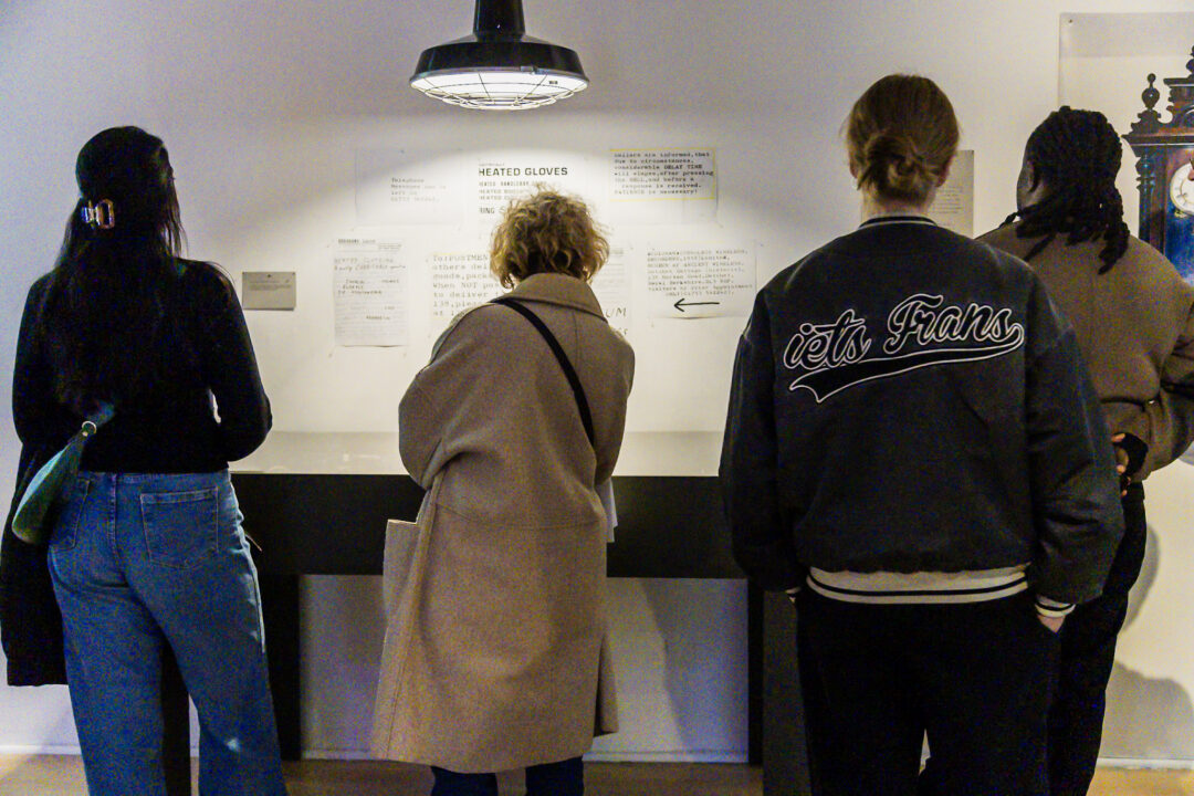 A photograph of people attending an exhibition launch