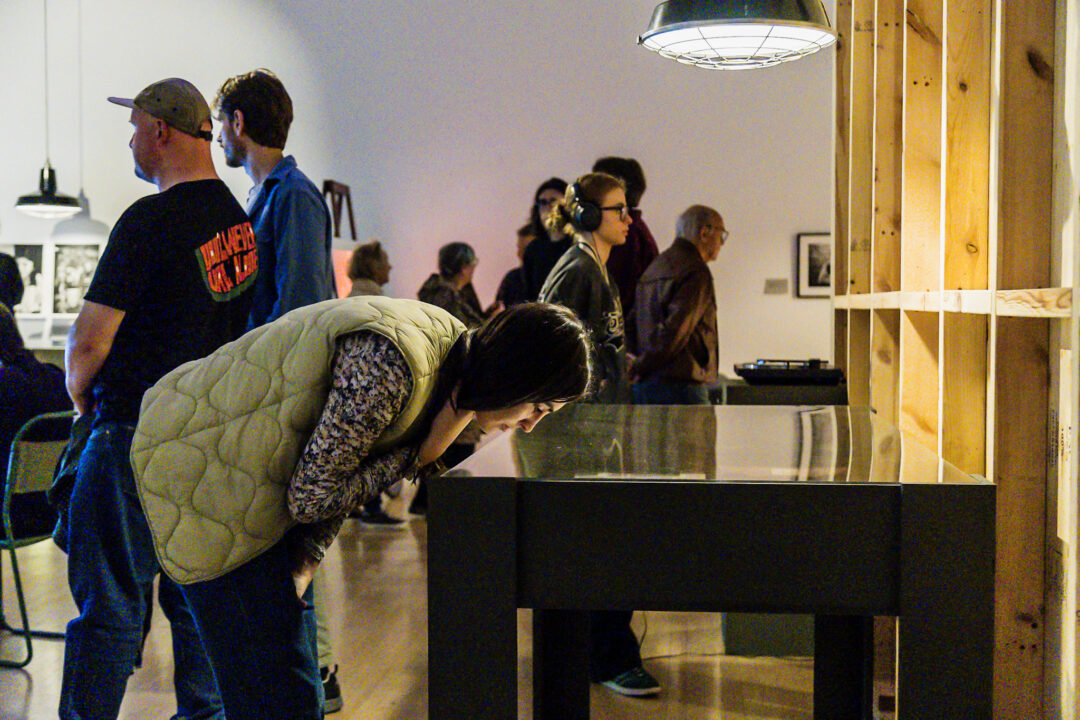 A photograph of people attending an exhibition launch