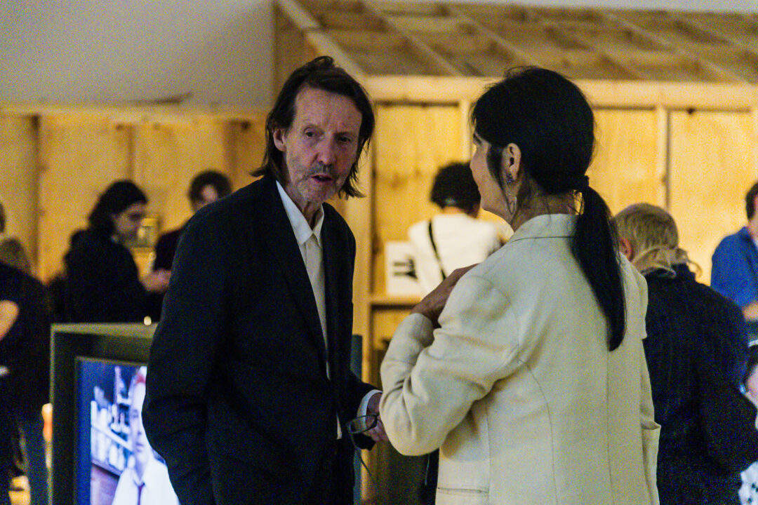 A photograph of people attending an exhibition launch