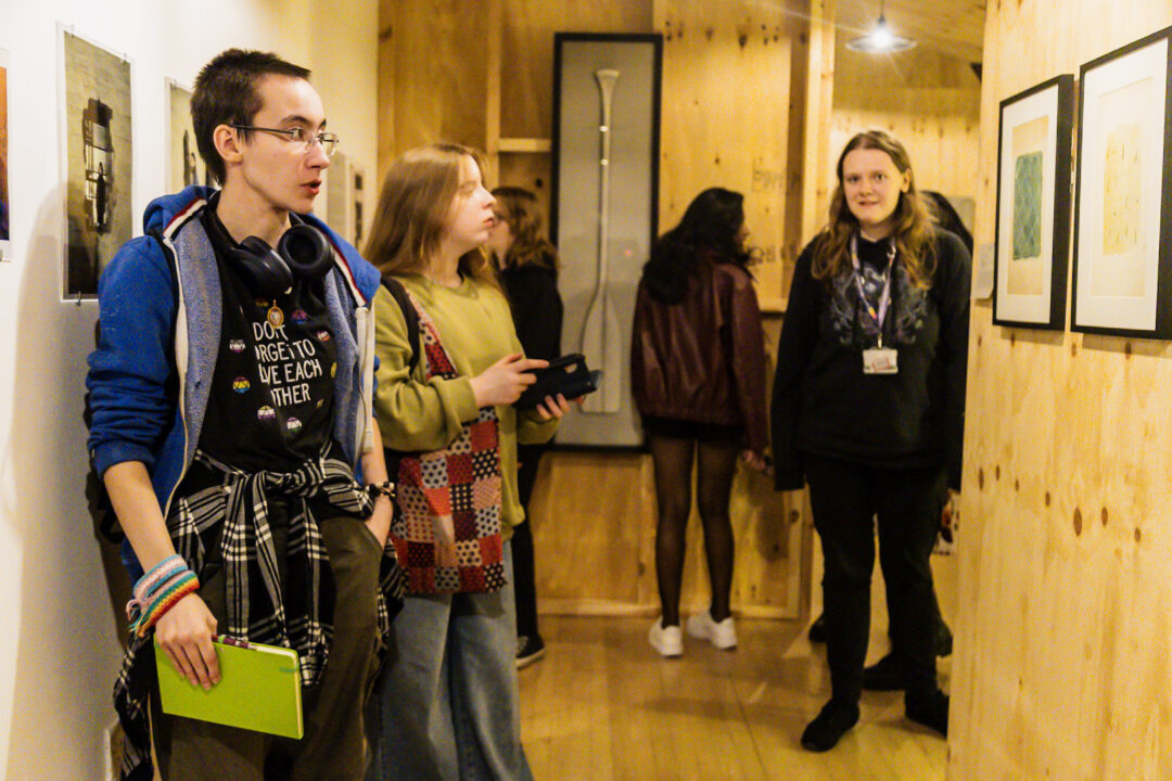 A photograph of people attending an exhibition launch