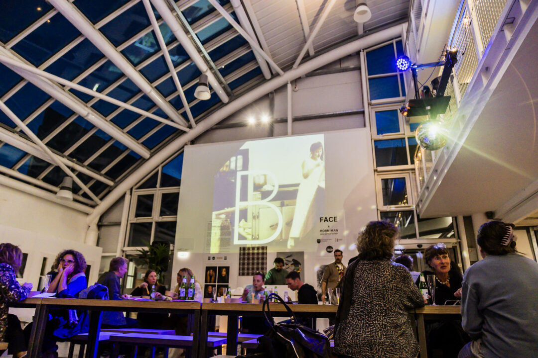 A photograph of people attending an exhibition launch