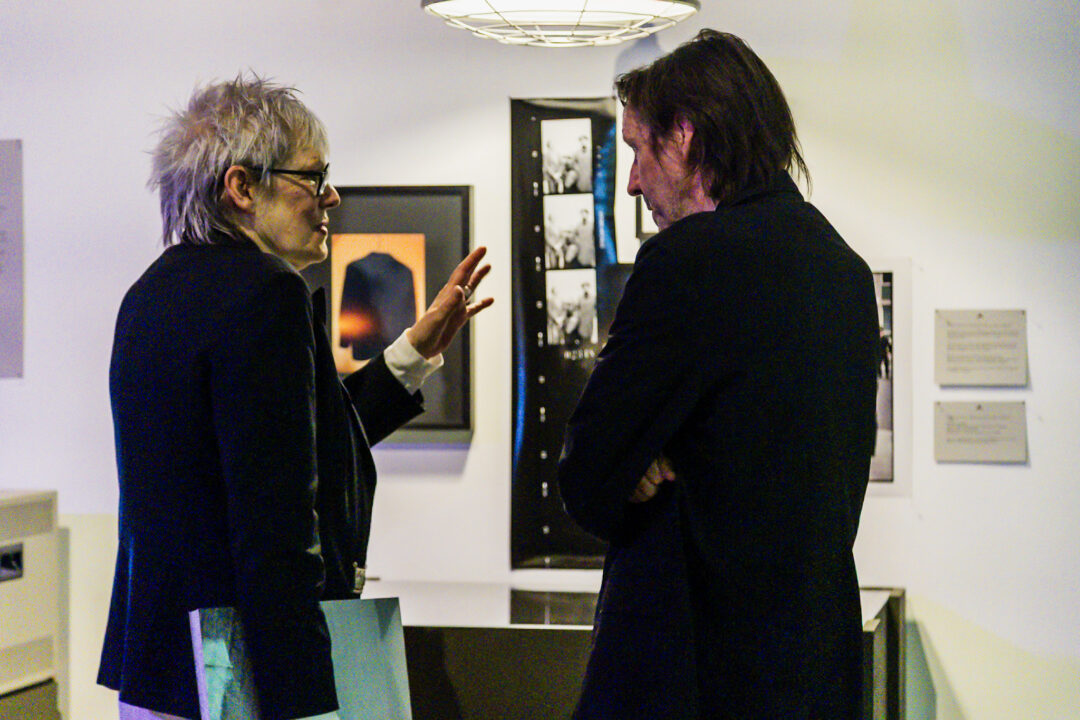 A photograph of people attending an exhibition launch