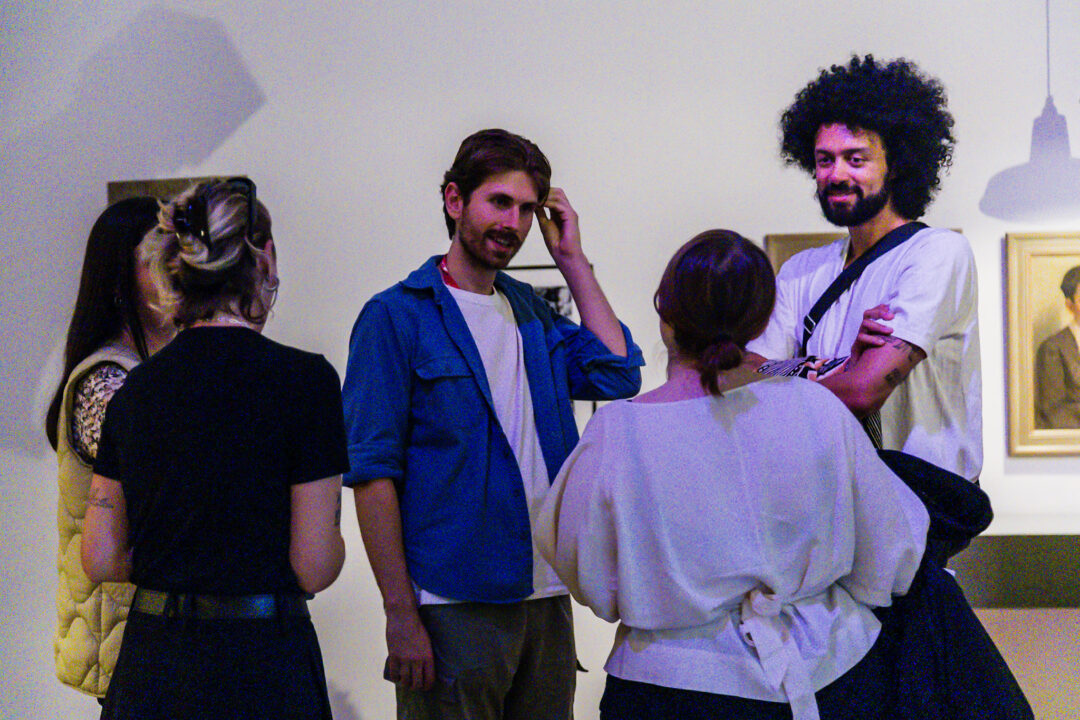 A photograph of people attending an exhibition launch