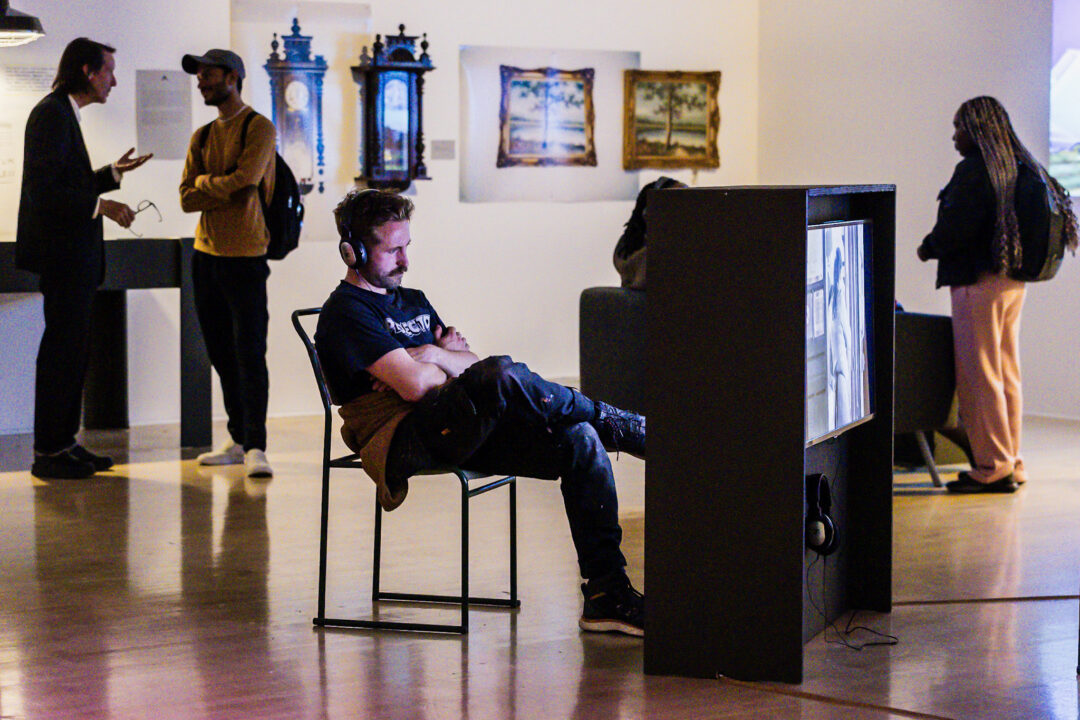 A photograph of people attending an exhibition launch